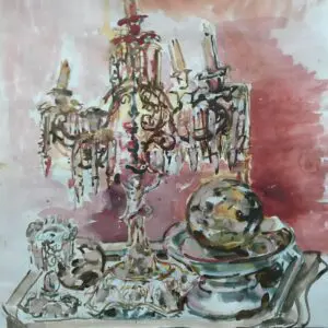 An ornate chandelier and decorative items on a reflective surface with a pink background.