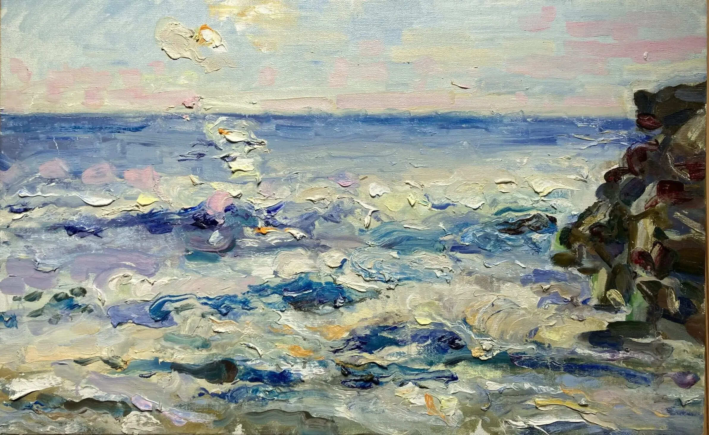 Pastel horizon with choppy surf and cliffs