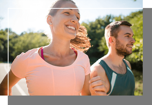 A woman and man running together outside.