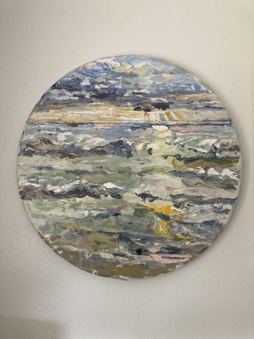 A painting of the ocean on a round canvas.