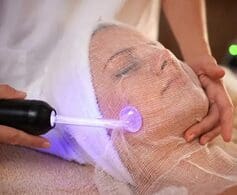 a woman getting a facial with a tool