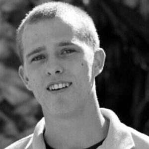 Smiling person in black and white portrait.